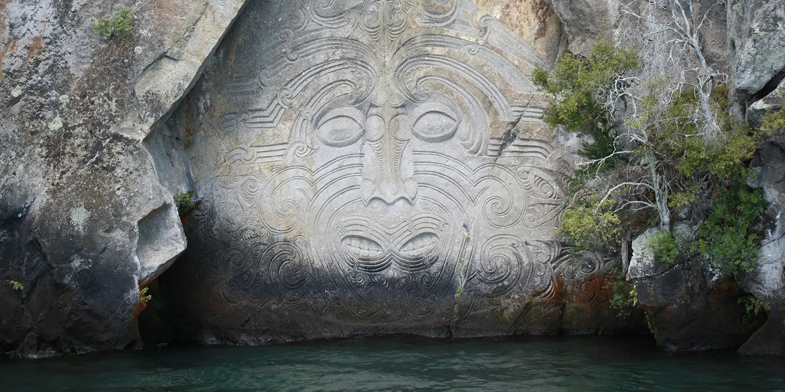 Moari carving in rock wall at Lake Taupo in New Zealand